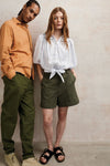 harvestclub-harvest-club-leuven-komodo-SS25-SPECTRE-SHIRT-ORANGE---MAKULU-TROUSERS-KHAKI---MAGIC-BLOUSE---EMMIE-SHORTS-KHAKI